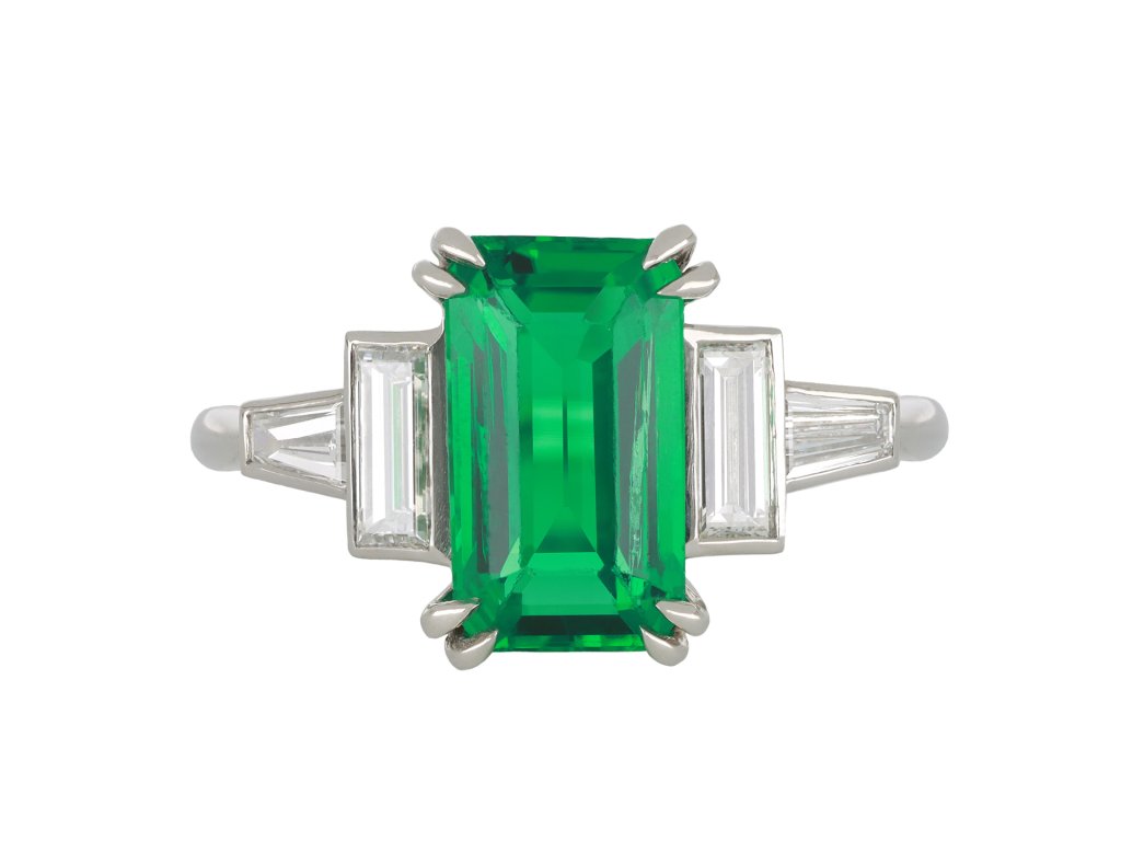 Colombian emerald and diamond flanked solitaire ring, circa 1950