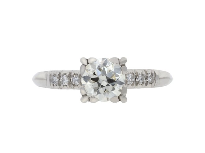 Flanked solitaire diamond ring, circa 1950.