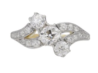 Edwardian diamond three stone cross over ring, circa 1910.     