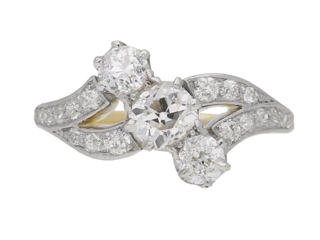 front view Antique diamond three stone cross over ring, circa 1910.     