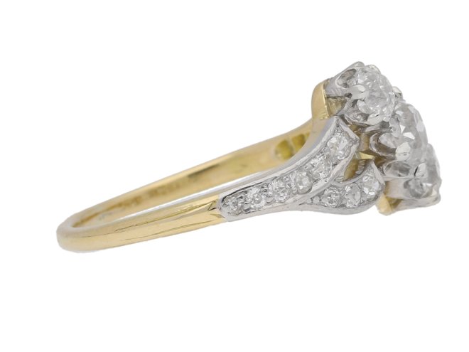 side view Antique diamond three stone cross over ring, circa 1910.     