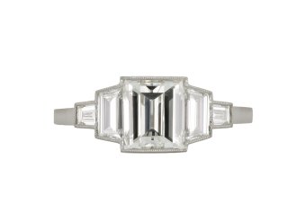 Art Deco step cut diamond flanked solitaire ring, circa 1925. 