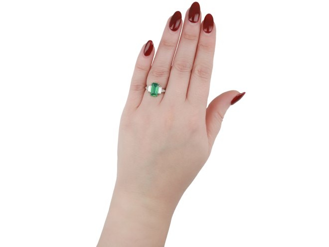 Colombian emerald and diamond flanked solitaire ring, circa 1950