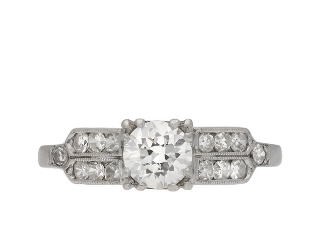 Diamond flanked solitaire ring, American, circa 1940.  Hatton Garden