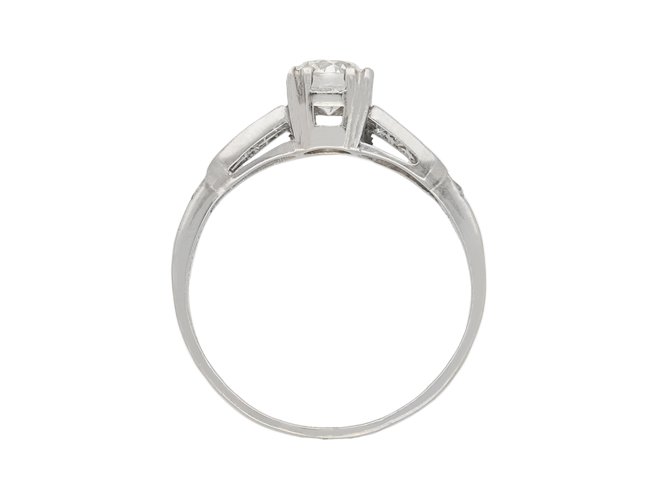 Diamond flanked solitaire ring, American, circa 1940.  Hatton Garden